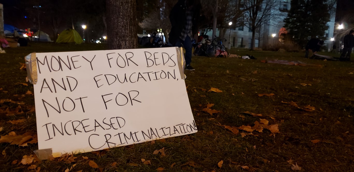 sign reads money for beds and education not for increased criminalization